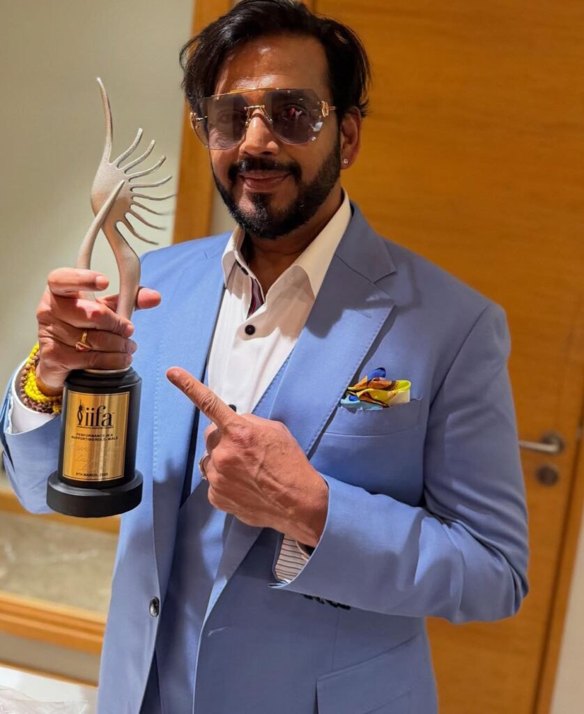 Ravi Kishan smiling with their award iifa